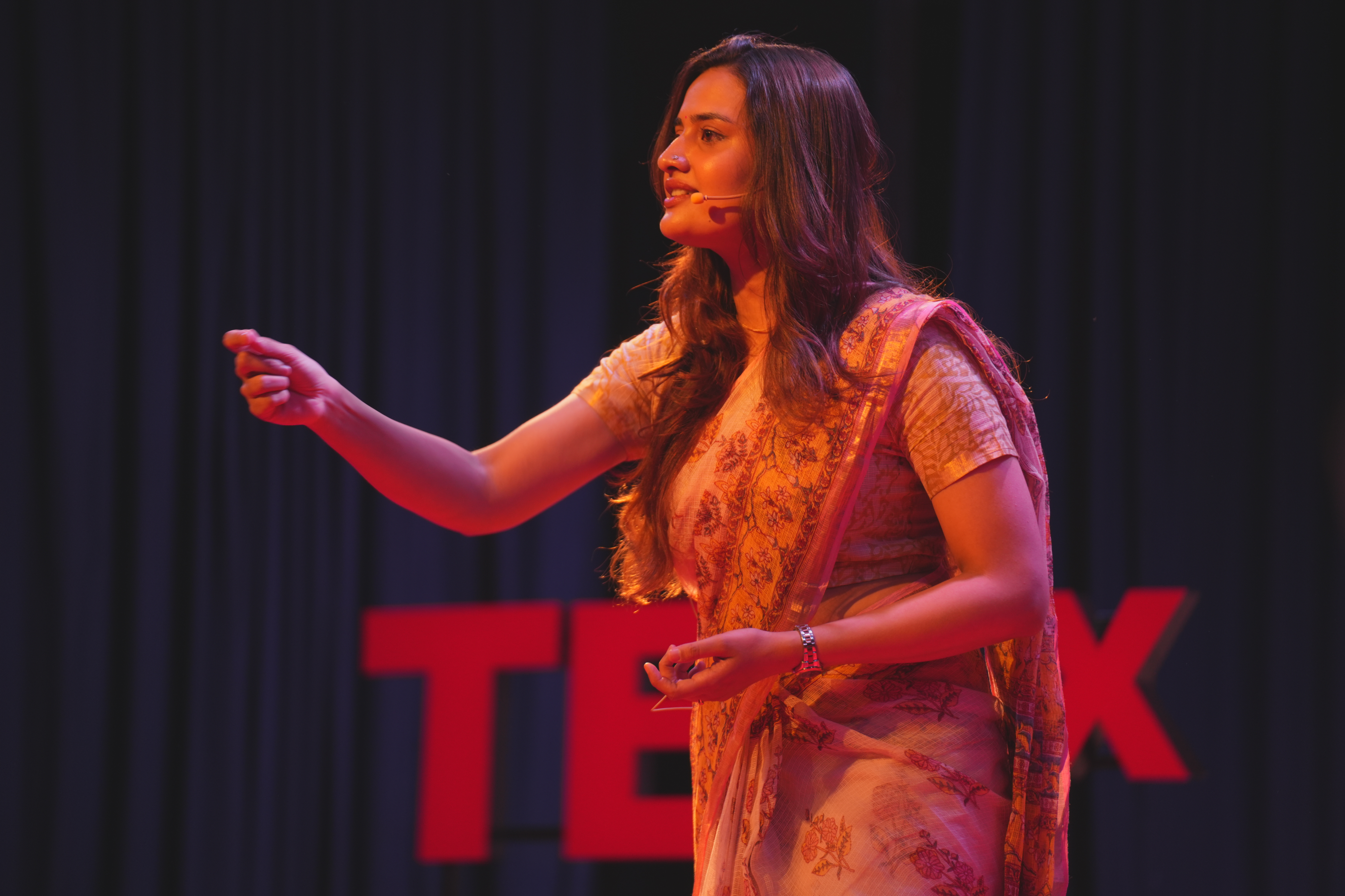 Sonia Patwardhan speaking on a TEDx stage